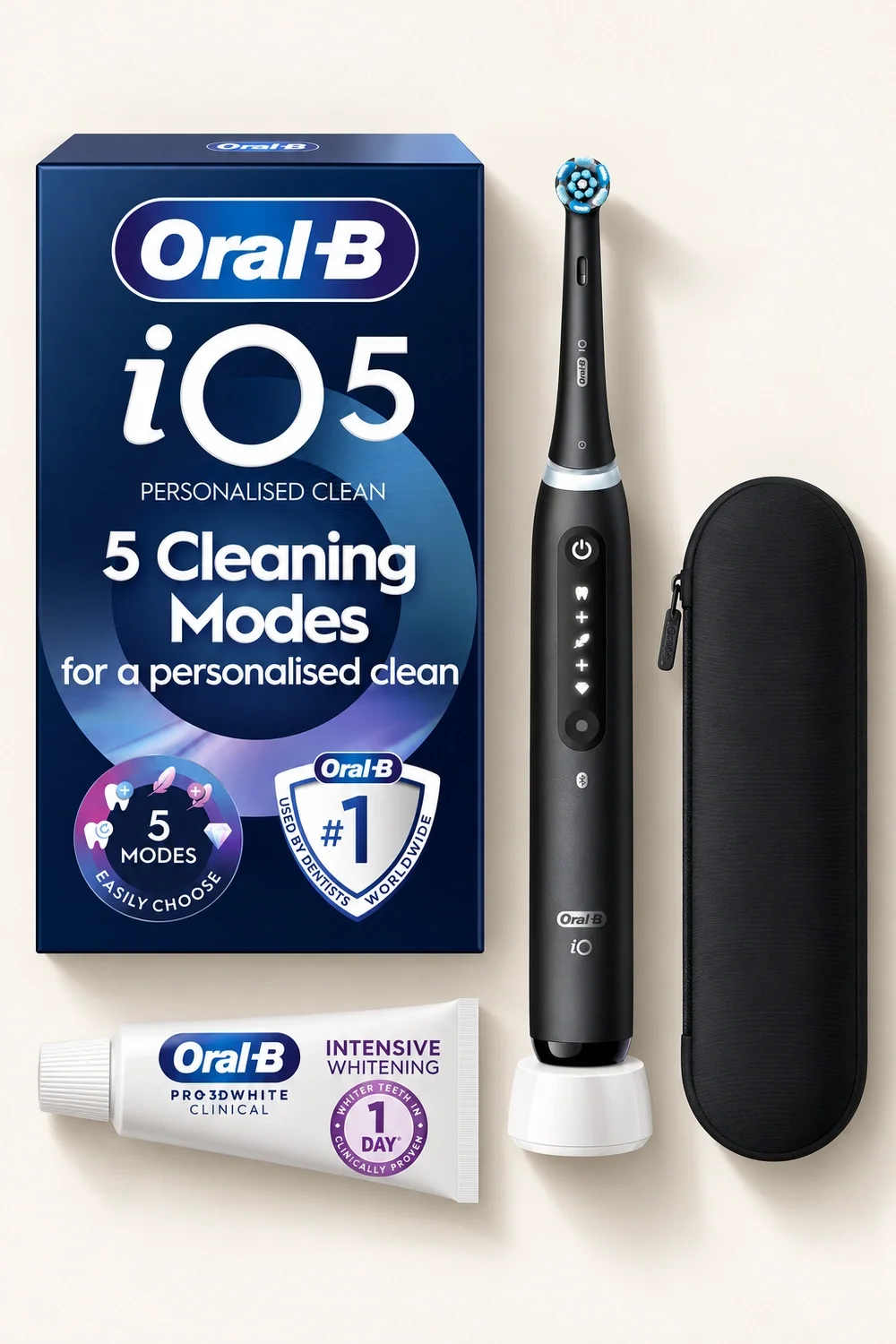 Oral-B iO5 Matt Black toothbrush bundle with travel case and toothpaste arranged in a flat lay